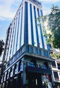 a tall building with a sign in front of it at CKC Thien Duong Hotel in Dong Hoi