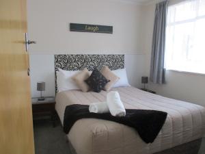 a bedroom with a large bed with two pillows at High Street Living Motel in Picton