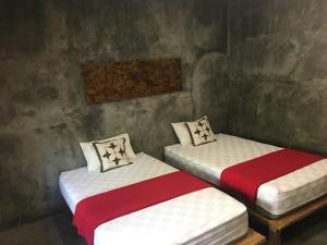 Ein Bett oder Betten in einem Zimmer der Unterkunft Watukarung Ristu Homestay