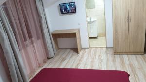 a room with a bed and a table and a bathroom at Casa Soral in Uriu