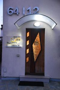 a building with a door with a sign on it at Marameo B&B in Udine