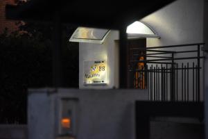 a building with a sign on the front of it at Marameo B&B in Udine