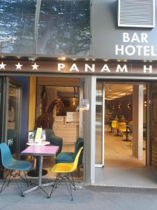 a restaurant with a table and chairs in front of it at HOTEL PARIS PANAM-PERE LACHAISE-PLACE GAMBETTA-HOPITAL TENON-REPUBLIQUe in Paris