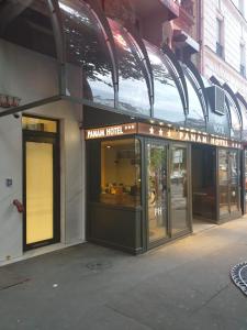 a building with an entrance to a banana hotel at Panam Hotel PARIS GAMBETTA- Place Gambetta-Mairie du 20 emme in Paris