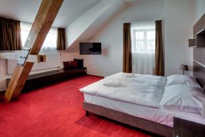 Postel nebo postele na pokoji v ubytování Hotel Zámecká Sýpka