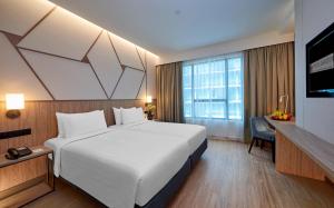 Postel nebo postele na pokoji v ubytování Swiss-Garden Hotel Bukit Bintang Kuala Lumpur