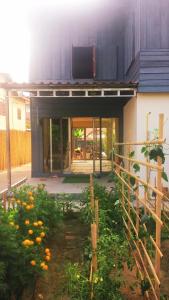 a house with a garden with oranges in front of it at Vanpila in Savannakhet