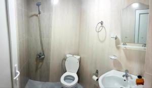 a bathroom with a shower and a toilet and a sink at Guesthouse Maria in Sarpi +44 photos