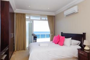 a bedroom with a bed with a view of the ocean at Ballito Manor Beach 405 - FAMILY ONLY - With Generator in Ballito