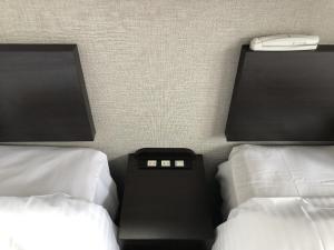 Postel nebo postele na pokoji v ubytování Hotel Tetora Kyoto Station