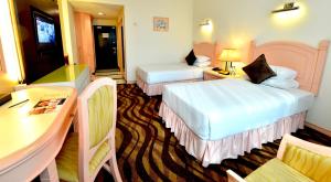 Voodi või voodid majutusasutuse Emerald Puteri Hotel toas