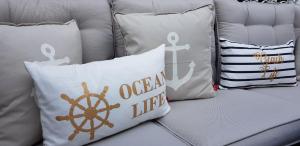 a group of pillows sitting on a couch with a nautical at Apartment Villa Zur Altstadt Sassnitz in Sassnitz