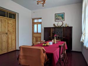 a dining room with a table with fruit on it at Tatev Guest House in Tatʼev