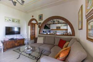 a living room with a couch and a table at Villa Romantica Sea View in Camaiore