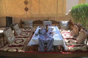 a dining table with a blue and white table cloth at Guest House Khiva ,, BOYJON OTA " in Khiva