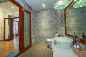 a bathroom with a tub and a toilet and a mirror at Hoi An Sea Village Homestay in Hoi An +58 photos
