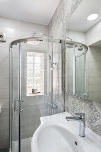 a bathroom with a white sink and a shower at Magnolia Luxury Apartments in Falasarna
