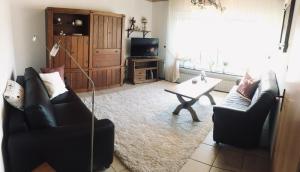 a living room with two couches and a coffee table at Ferienwohnung zum Nationalpark in Mechernich