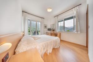 a bedroom with a bed and a window at Hotel Karinhall in Trento