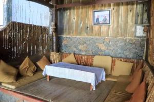 a room with a couch and a table in a room at Eka Purnama Cottages in Amed