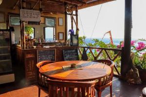 a restaurant with a table and chairs and the ocean at Eka Purnama Cottages in Amed +41 photos