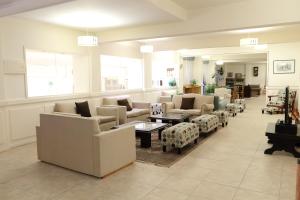 una gran sala de estar con sofás y mesas. en Hotel Cottbus en San Carlos de Bariloche