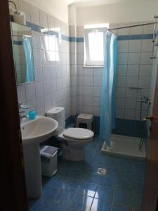 a bathroom with a toilet and a sink and a shower at Nikos Apartments in Falasarna