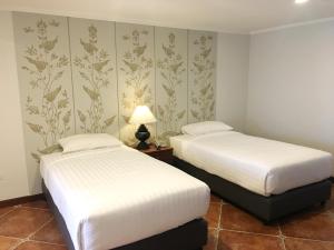 Postel nebo postele na pokoji v ubytování Viangbua Mansion