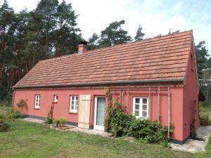czerwony dom z czerwonym dachem w obiekcie Ferienhaus am Wald mit Klavier, Holzofen, Sauna w mieście Alt Jabel