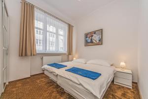 um quarto com uma cama branca e uma janela em Baltic Plaza Gdynia - MAXIMAL em Gdynia