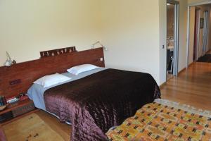 una camera da letto con un grande letto con testiera in legno di Casa LLEVADORA - Villa amb piscina privada a PALS a Pals Altre 62 foto