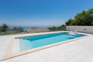a swimming pool with a swan in the middle at Villa Marta in Opatija