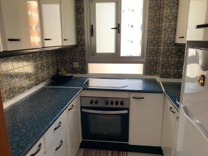 a kitchen with a sink and a stove at Beach Benidorm in Benidorm