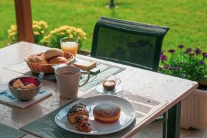 a table with a plate of pastries and drinks on it at B&B Il Tramonto in Pastrengo
