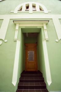 a stairway leading to a door with the wordarma at Pension Kokel in Dumbrăveni