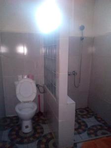 a bathroom with a toilet with a light above it at IVATO Airport STUDIOS CHAMBRES in Ivato +23 photos