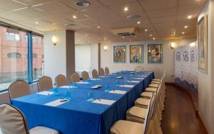 a conference room with a long table and chairs at Hotel MS Maestranza Málaga in Málaga