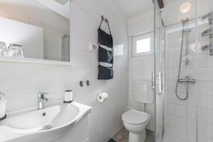a bathroom with a toilet and a sink and a shower at B&B Carmela in Umag