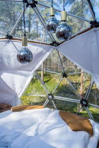 a bedroom in a dome tent with lights at GLØD Aurora Canvas Dome in Alta