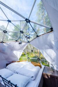 a room with two beds in a tent at GLØD Aurora Canvas Dome in Alta