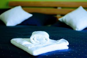 a white towel sitting on top of a bed at STOP&RELAX Apartment in Liptovská Osada