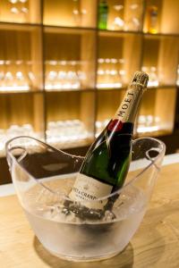 a bottle of champagne in a glass bowl on a table at The Gate in Porto