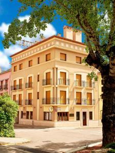 a large yellow building with a tree in front of it at Hotel Anna in Cocentaina