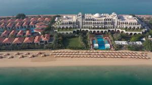 a beach scene with a large building at Jumeirah Zabeel Saray in Dubai
