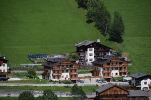 a group of houses on a hill with a green field at Cesa Fossal in Colle Santa Lucia