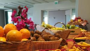 a bunch of baskets of fruit on a table at Chia Laguna - Hotel Village in Chia