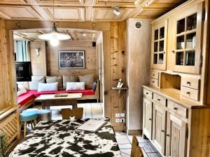 a living room with a couch and a table at Chalet Marie Claire in Notre-Dame-de-Bellecombe
