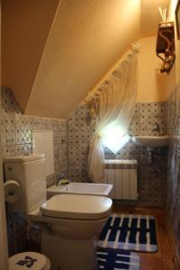 a bathroom with a toilet and a sink at Villa Florio in Jūrmala