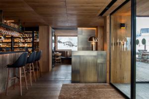 a kitchen with a refrigerator and a table in it at Grau Roig Andorra Boutique Hotel & Spa in Grau Roig