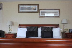 a bed in a hotel room with two pillows on it at Mallyan Spout Hotel in Goathland